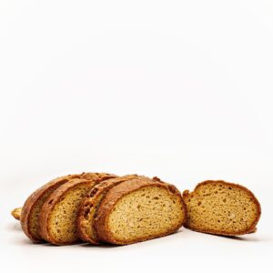 Pieza de pan de hogaza con calabaza, de corteza fina y suave de un color muy dorado debido a la caramelización de la propia calabaza, con una miga firme y jugosa a la vez que esponjosa, sin gluten.